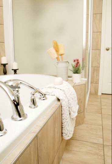 Inspiration for a mid-sized transitional master beige tile and ceramic tile ceramic tile and beige floor home design remodel in Calgary with beige walls and a hinged shower door