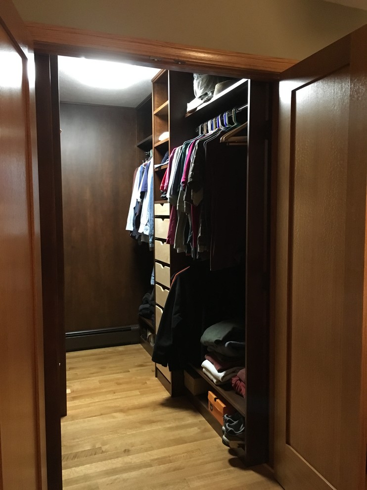 Example of a mid-sized transitional light wood floor walk-in closet design with open cabinets and dark wood cabinets