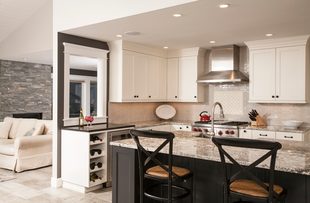 Photo of a large contemporary l-shaped eat-in kitchen in Seattle with a farmhouse sink, recessed-panel cabinets, white cabinets, granite benchtops, beige splashback, stainless steel appliances, porcelain floors and with island.