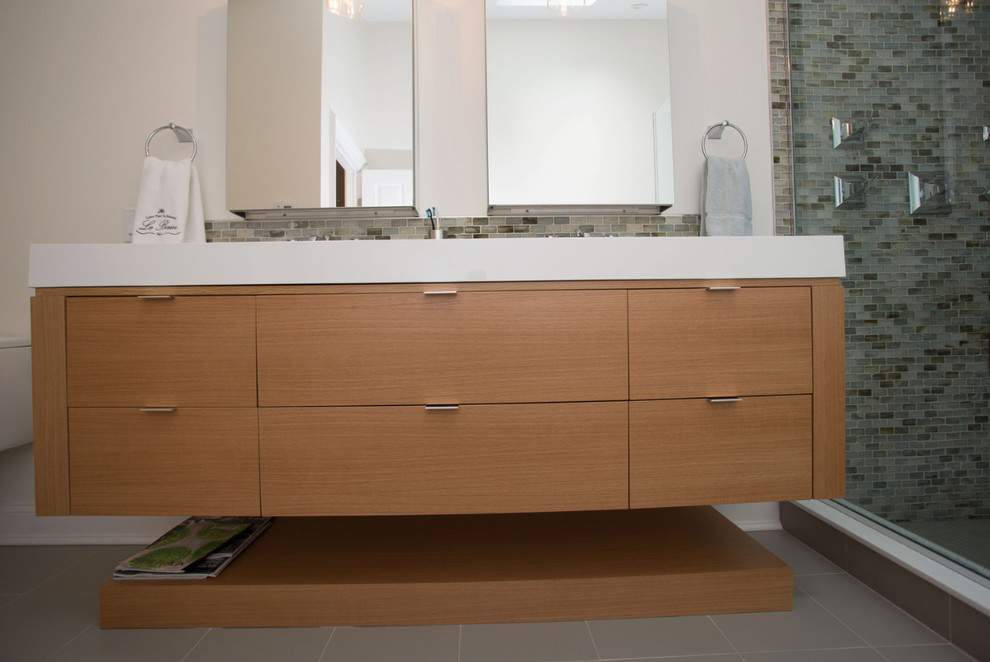 Mid-sized minimalist master double-sink bathroom photo in New York with flat-panel cabinets, medium tone wood cabinets, white walls, an undermount sink, quartz countertops, a hinged shower door and a built-in vanity
