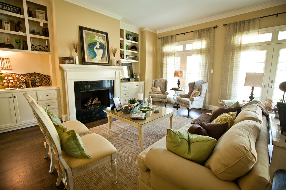 Photo of a large traditional living room in Other with beige walls, dark hardwood floors and a standard fireplace.