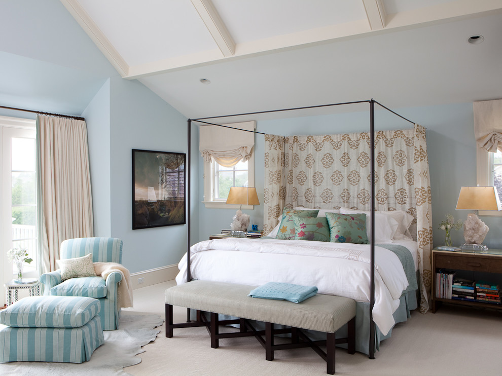Photo of an expansive transitional master bedroom in New York with blue walls and carpet.