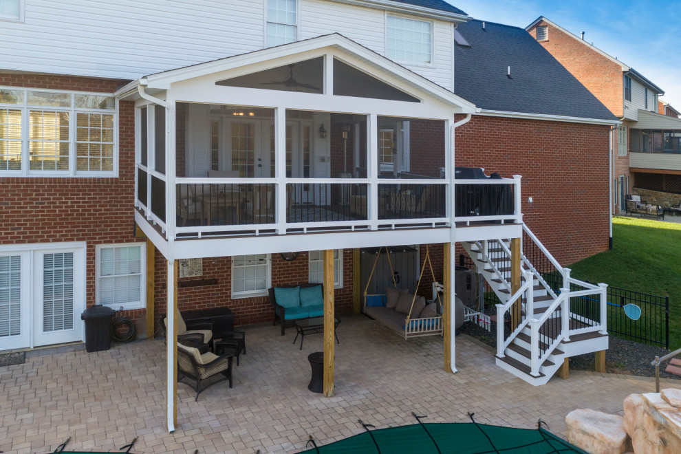 Cette photo montre un porche d'entrée de maison arrière chic de taille moyenne avec une moustiquaire, une extension de toiture et un garde-corps en matériaux mixtes.