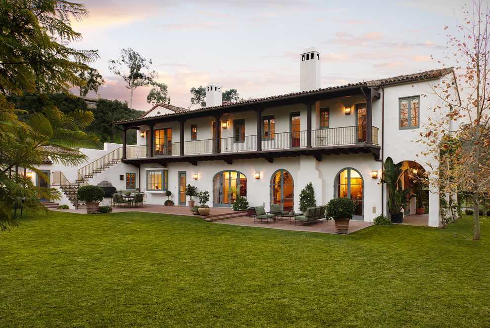 Inspiration for a large mediterranean two-storey stucco white exterior in Santa Barbara with a gable roof.