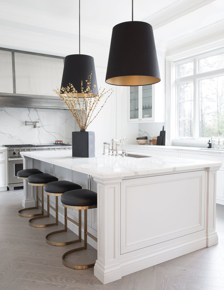 Design ideas for a contemporary u-shaped kitchen in Toronto with an undermount sink, recessed-panel cabinets, white cabinets, white splashback, stone slab splashback, stainless steel appliances, with island, grey floor and white benchtop.