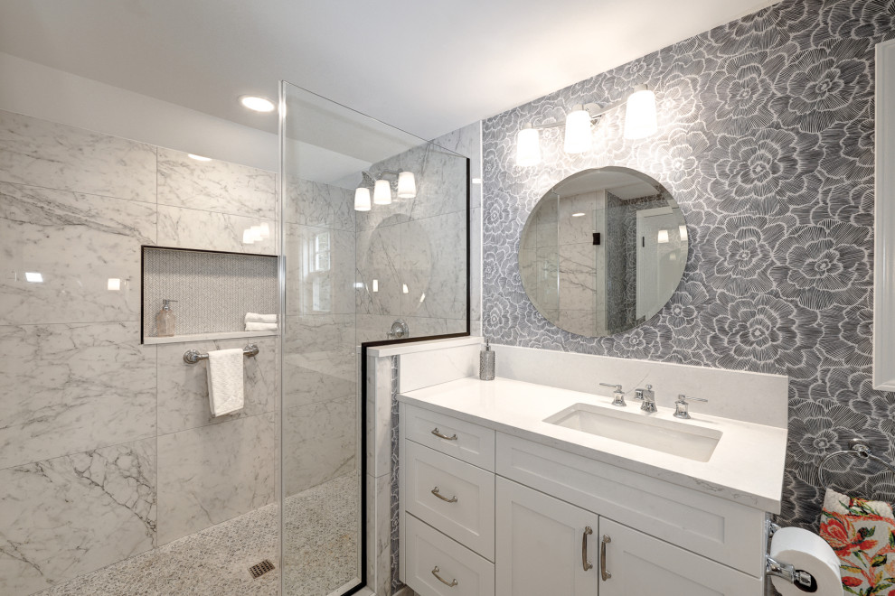 Photo of a traditional master bathroom in Portland with shaker cabinets, white cabinets, an alcove shower, a one-piece toilet, black and white tile, grey walls, mosaic tile floors, an undermount sink, engineered quartz benchtops, grey floor, a hinged shower door, white benchtops, a niche, a single vanity, a built-in vanity and wallpaper.