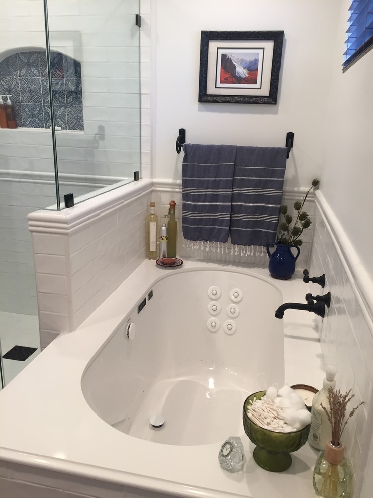 Mid-sized country master bathroom in Los Angeles with furniture-like cabinets, brown cabinets, a drop-in tub, a one-piece toilet, white tile, subway tile, white walls, terra-cotta floors, a drop-in sink, engineered quartz benchtops, red floor and a hinged shower door.