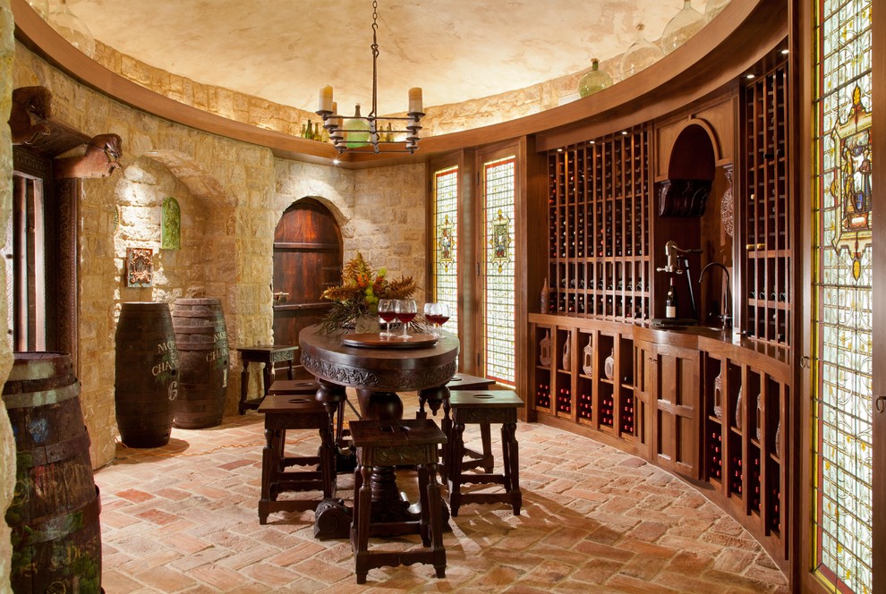Photo of a mediterranean wine cellar in Denver with brick floors and pink floor.