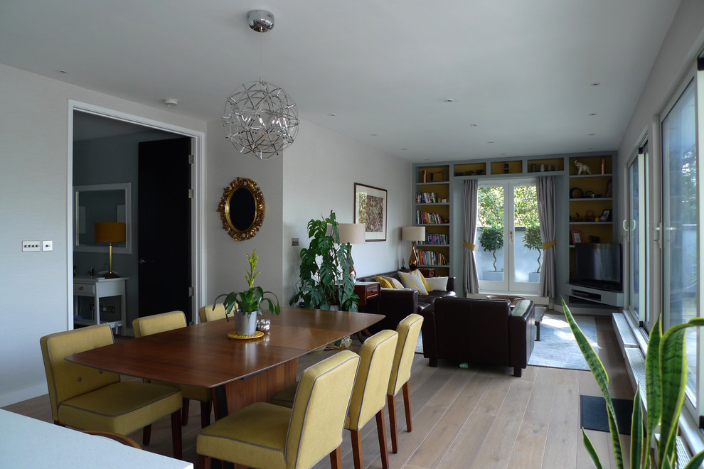 This is an example of a large contemporary open plan dining in London with grey walls, medium hardwood floors and brown floor.