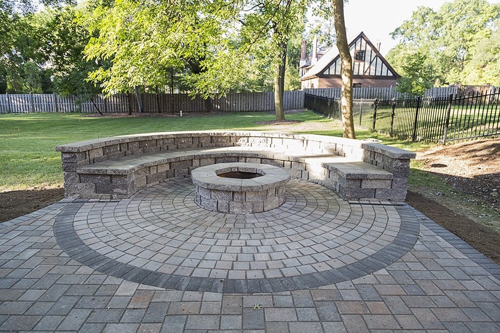 This is an example of a large backyard patio in St Louis with a fire feature and concrete pavers.