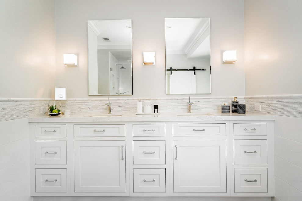 Large transitional master bathroom in Los Angeles with shaker cabinets, white cabinets, a freestanding tub, an alcove shower, matchstick tile, grey walls, marble floors, an undermount sink, engineered quartz benchtops and white tile.