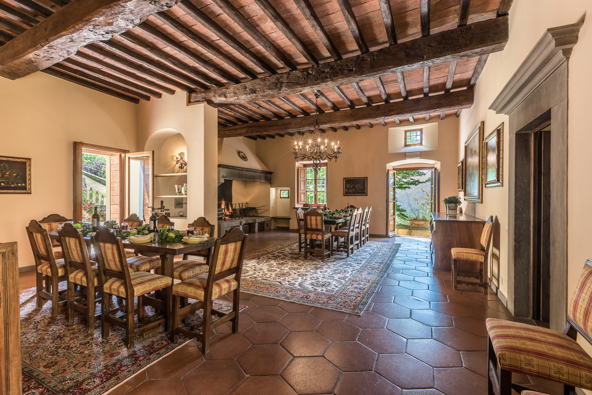 Design ideas for an expansive country separate dining room in Florence with beige walls, limestone floors, a standard fireplace, a stone fireplace surround and grey floor.