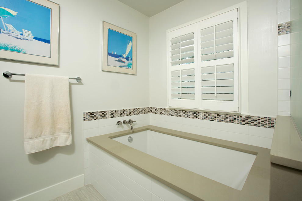 Example of a mid-sized transitional master brown tile and mosaic tile porcelain tile corner bathtub design in DC Metro with an undermount sink, recessed-panel cabinets, white cabinets, quartz countertops, a two-piece toilet and white walls