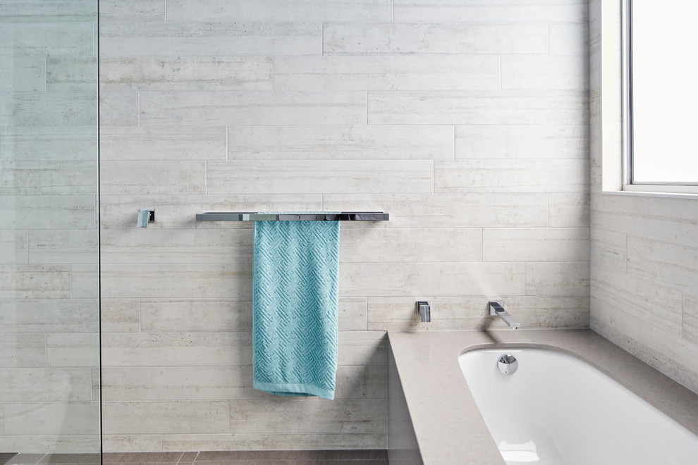 Photo of a mid-sized modern master bathroom in Wollongong with grey cabinets, an undermount tub, an open shower, a one-piece toilet, gray tile, ceramic floors and engineered quartz benchtops.