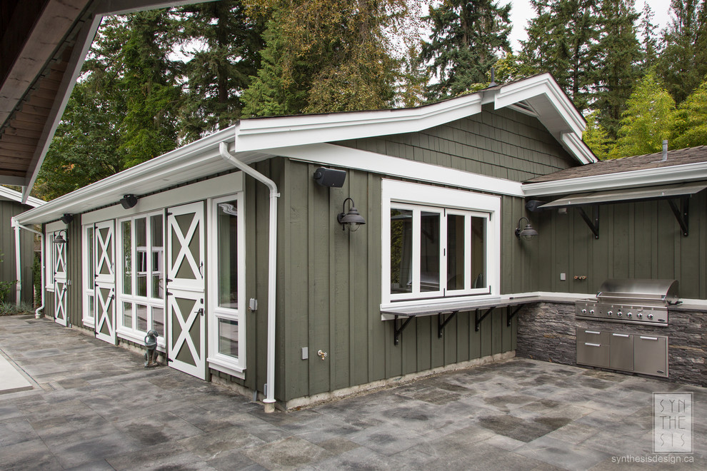Design ideas for a traditional one-storey green house exterior in Vancouver with wood siding and a shingle roof.