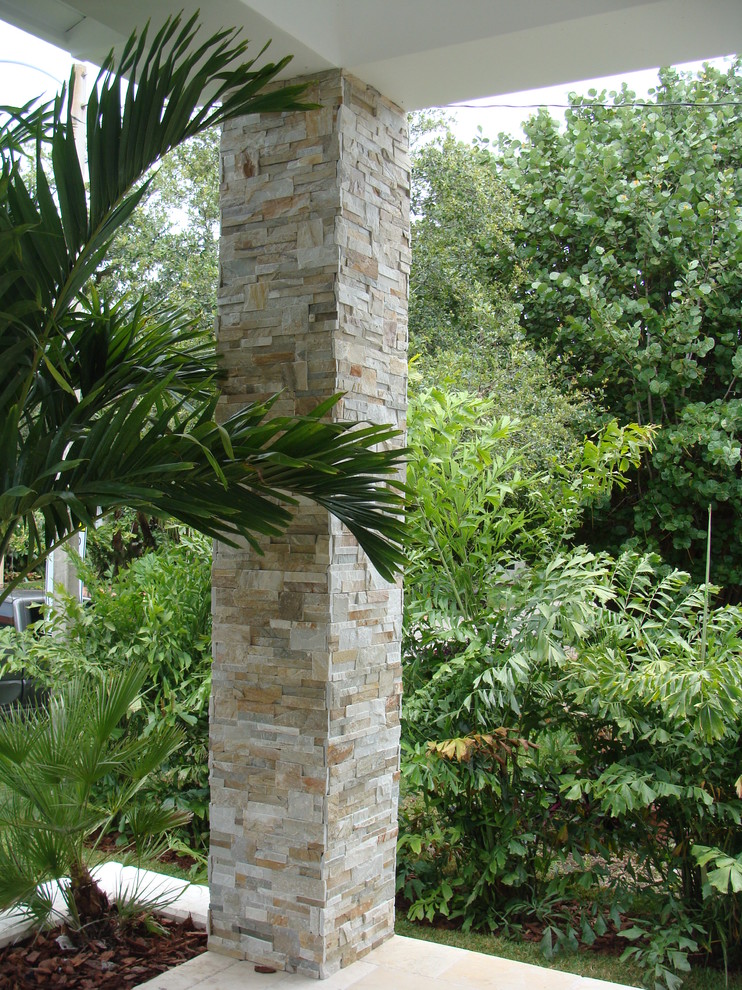 Contemporary stone house exterior idea in Miami