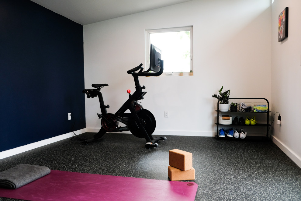 Inspiration for a mid-sized midcentury multipurpose gym in Denver with white walls and black floor.