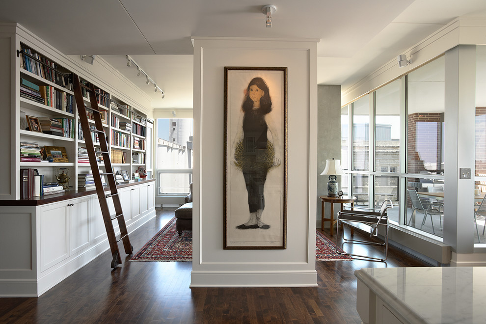 Inspiration for a traditional family room in Minneapolis with a library, white walls and dark hardwood floors.