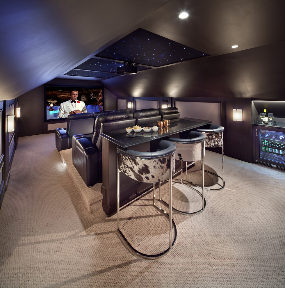 This is an example of a large contemporary enclosed home theatre in DC Metro with brown walls, carpet and a projector screen.