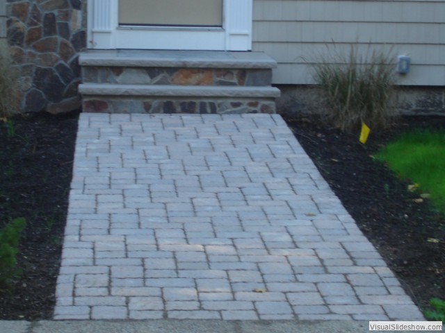 Example of a large classic two-story stone home design design in Boston with a shed roof