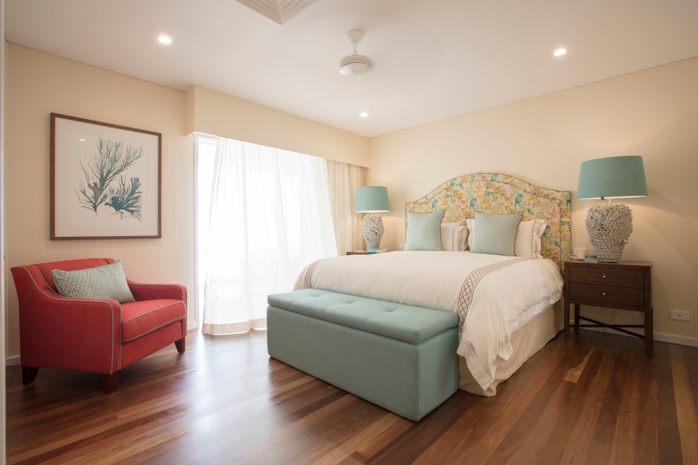 Inspiration for a beach style bedroom in Cairns with yellow walls, dark hardwood floors and no fireplace.