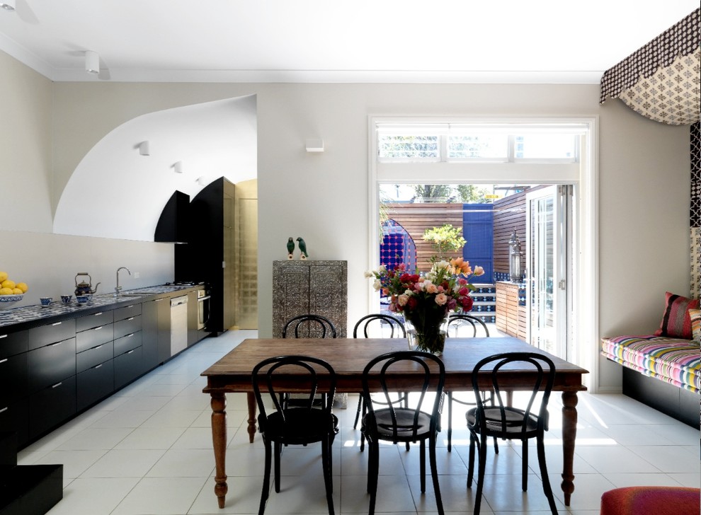 Mid-sized eclectic single-wall eat-in kitchen in Sydney with flat-panel cabinets, black cabinets, an undermount sink, beige splashback and stainless steel appliances.