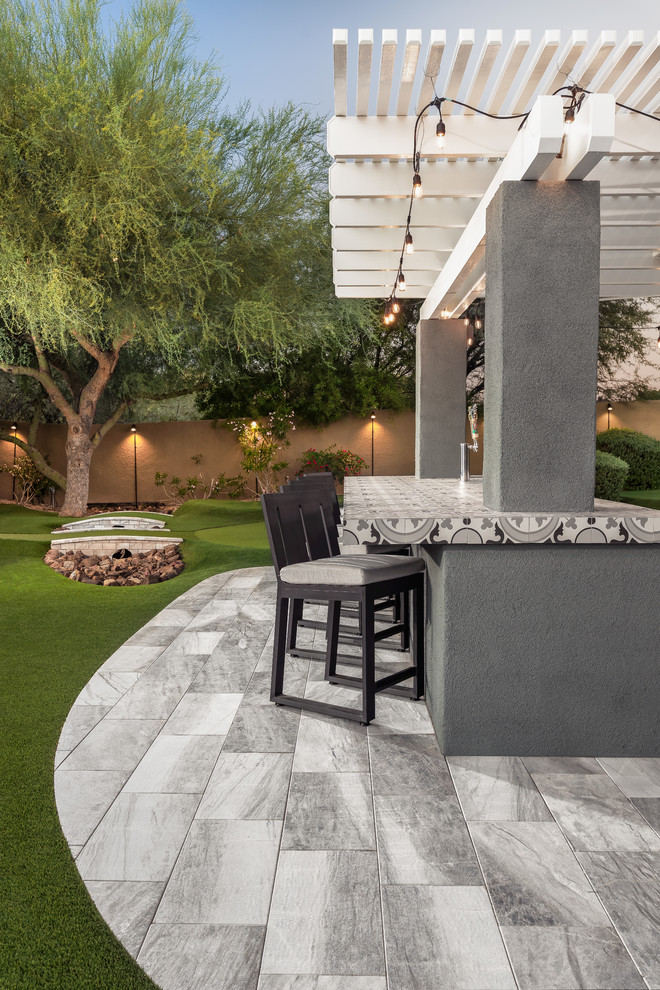 Inspiration for a large modern backyard garden in Phoenix with natural stone pavers.