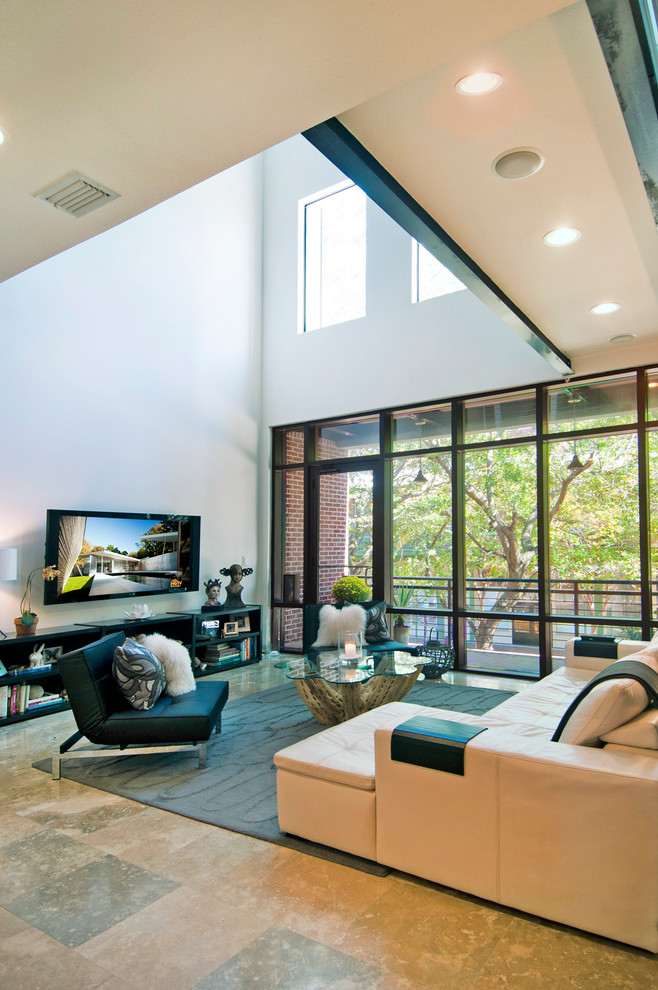 This is an example of a large contemporary open concept living room in Tampa with white walls, no fireplace and a wall-mounted tv.