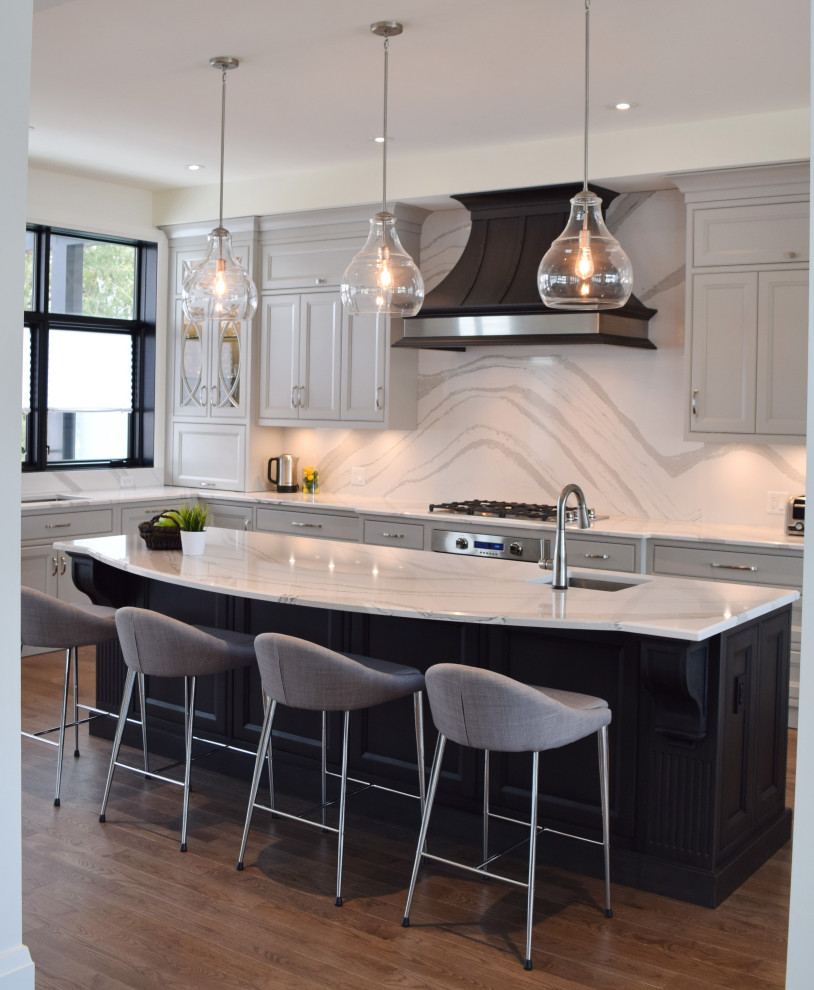 Large l-shaped medium tone wood floor and brown floor open concept kitchen photo in Ottawa with an undermount sink, recessed-panel cabinets, white cabinets, quartz countertops, white backsplash, quartz backsplash, paneled appliances, an island and white countertops