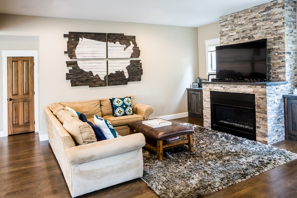 Mid-sized contemporary open concept living room in Denver with dark hardwood floors, a standard fireplace, beige walls, a stone fireplace surround, a freestanding tv and brown floor.