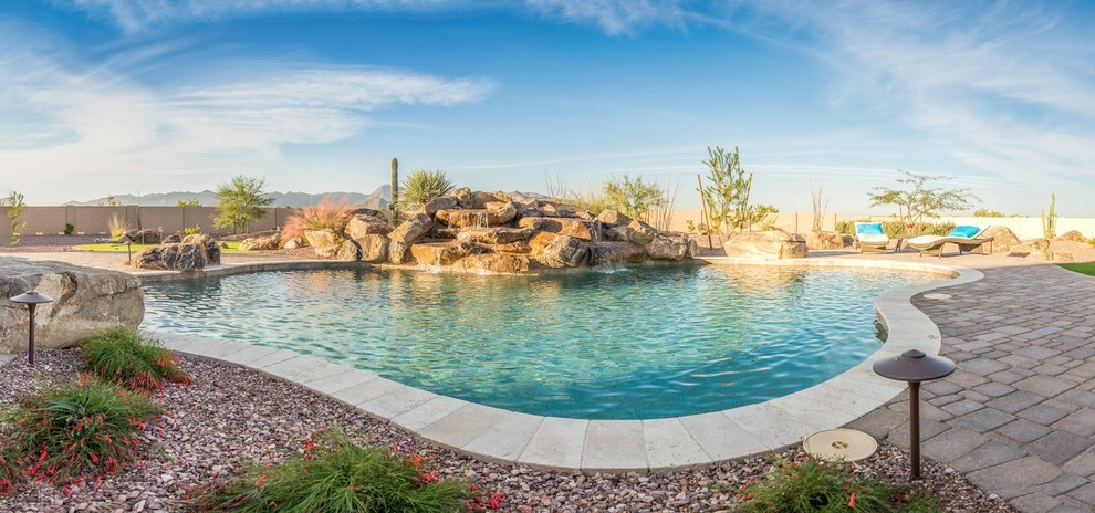 Example of a large backyard gravel full sun pool design for summer in Phoenix