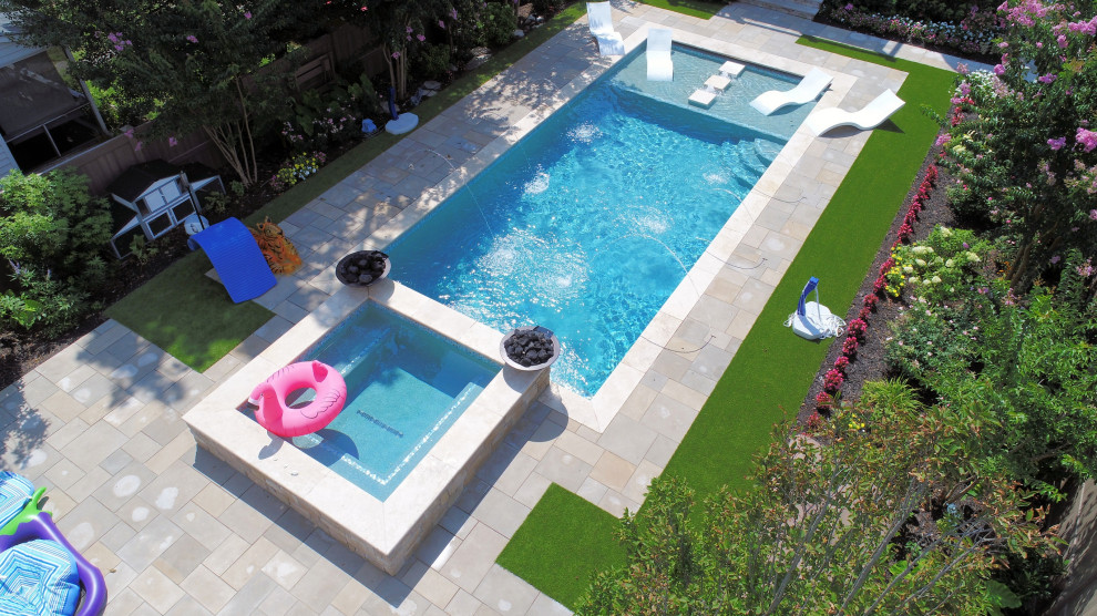 Photo of a mid-sized contemporary backyard rectangular pool in Other with a water feature and natural stone pavers.