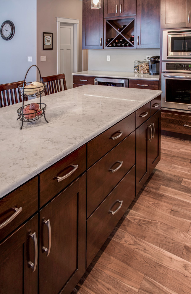 Inspiration for a large country u-shaped open plan kitchen in Other with a double-bowl sink, shaker cabinets, dark wood cabinets, granite benchtops, stainless steel appliances, medium hardwood floors and with island.