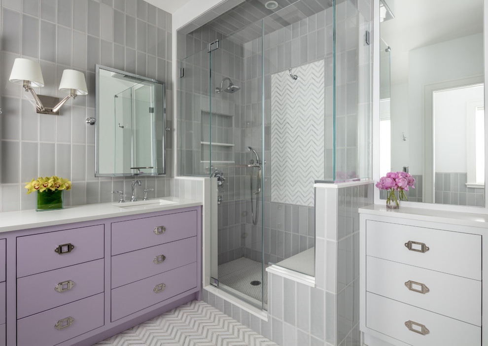 Transitional 3/4 bathroom in New York with flat-panel cabinets, purple cabinets, a corner shower, gray tile, grey walls, an undermount sink, multi-coloured floor, a hinged shower door and white benchtops.