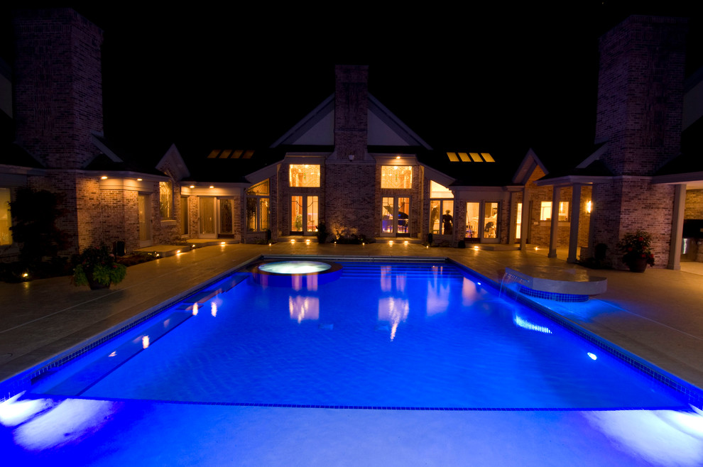 Inspiration for a large transitional backyard concrete paver and rectangular natural hot tub remodel in Cedar Rapids