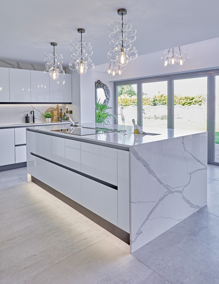 Design ideas for a large modern grey and white kitchen/diner in Other with white cabinets, quartz worktops, white splashback, an island, grey floors and white worktops.