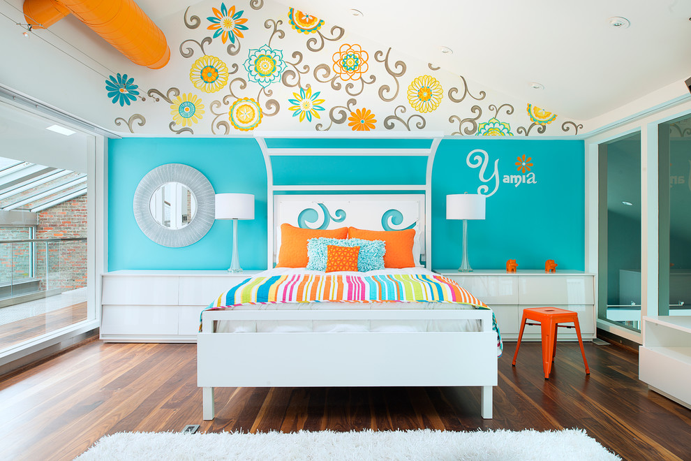 Photo of a beach style kids' room for girls in Other with dark hardwood floors and multi-coloured walls.