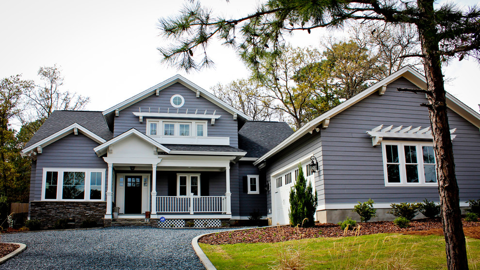 Design ideas for a large beach style two-storey blue exterior in Raleigh with wood siding and a gable roof.