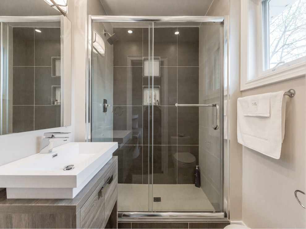Mid-sized modern master bathroom in Toronto with flat-panel cabinets, brown cabinets, a corner shower, a one-piece toilet, multi-coloured tile, porcelain tile, pink walls, cement tiles, a drop-in sink, engineered quartz benchtops, green floor, a sliding shower screen and white benchtops.