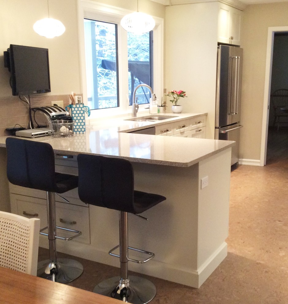 Transitional cork floor kitchen photo in Edmonton with white cabinets, quartzite countertops, gray backsplash, ceramic backsplash and stainless steel appliances