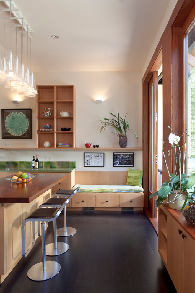 Inspiration for a modern kitchen in San Francisco with wood benchtops and green splashback.