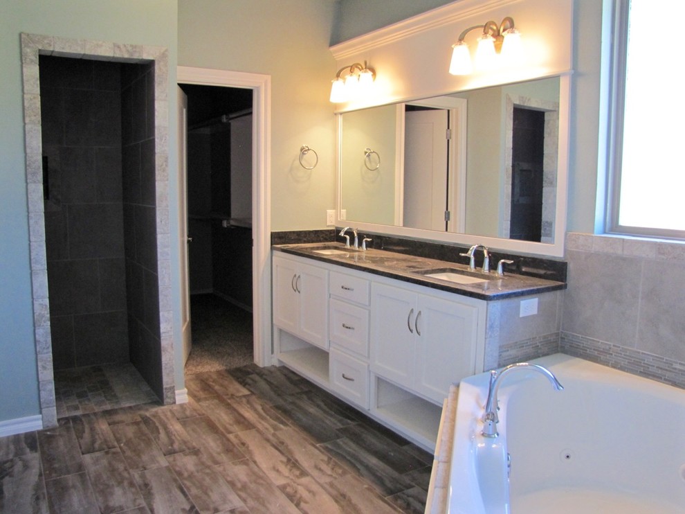Transitional master gray tile and ceramic tile ceramic tile corner bathtub photo in Oklahoma City with shaker cabinets, white cabinets, green walls, an undermount sink and granite countertops