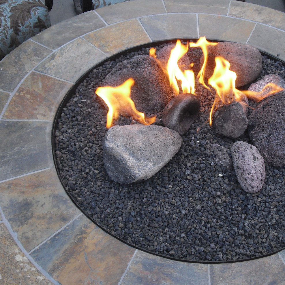 Inspiration for an expansive mediterranean backyard partial sun garden in Seattle with a fire feature and natural stone pavers.