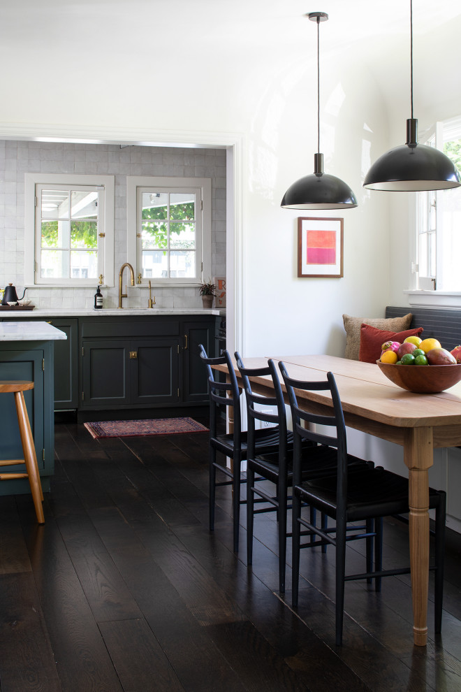 Inspiration for a small eclectic dining room in San Francisco with white walls, dark hardwood floors and brown floor.