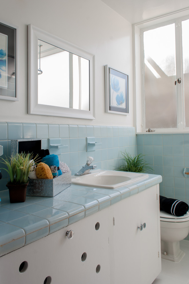 Photo of a midcentury bathroom in DC Metro with a drop-in sink and tile benchtops.