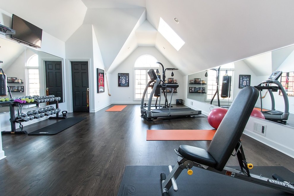 Design ideas for a mid-sized transitional multipurpose gym in Chicago with white walls, dark hardwood floors and brown floor.