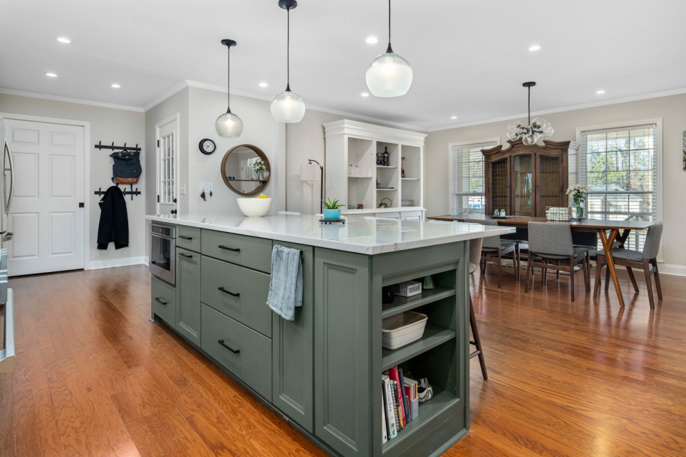 Inspiration for a large midcentury l-shaped open plan kitchen in Atlanta with a farmhouse sink, shaker cabinets, green cabinets, quartzite benchtops, white splashback, subway tile splashback, stainless steel appliances, dark hardwood floors, with island, brown floor and grey benchtop.