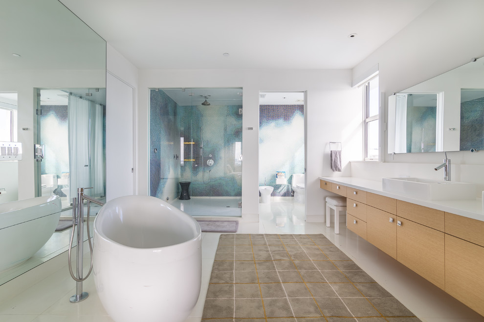 Design ideas for a large contemporary master bathroom in Miami with a vessel sink, flat-panel cabinets, light wood cabinets, a freestanding tub, an alcove shower, a one-piece toilet, white tile and white walls.