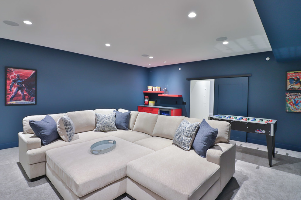 Photo of a large beach style enclosed home theatre in Other with blue walls, carpet, a wall-mounted tv and beige floor.