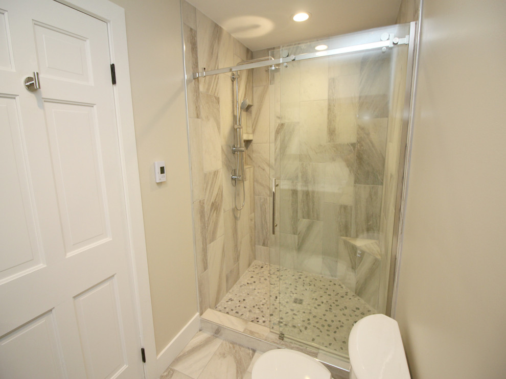 Medium sized contemporary shower room bathroom in Other with a walk-in shower, beige tiles, pebble tiles, beige walls, porcelain flooring, beige floors, a sliding door and a shower bench.